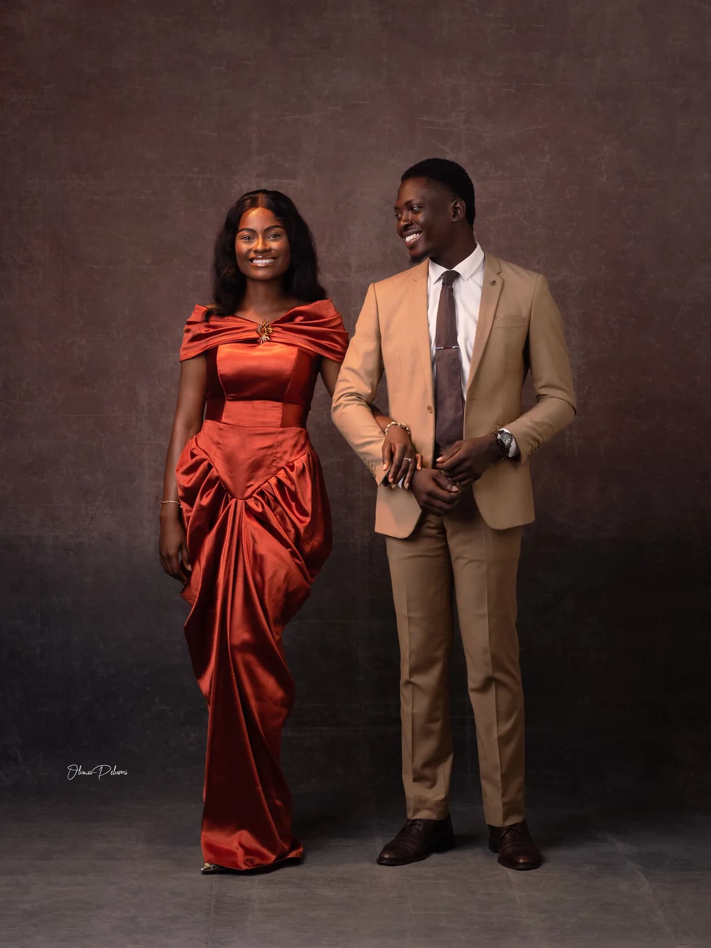 Asepe in a flowing gown beside Ajibola in a tailored suit