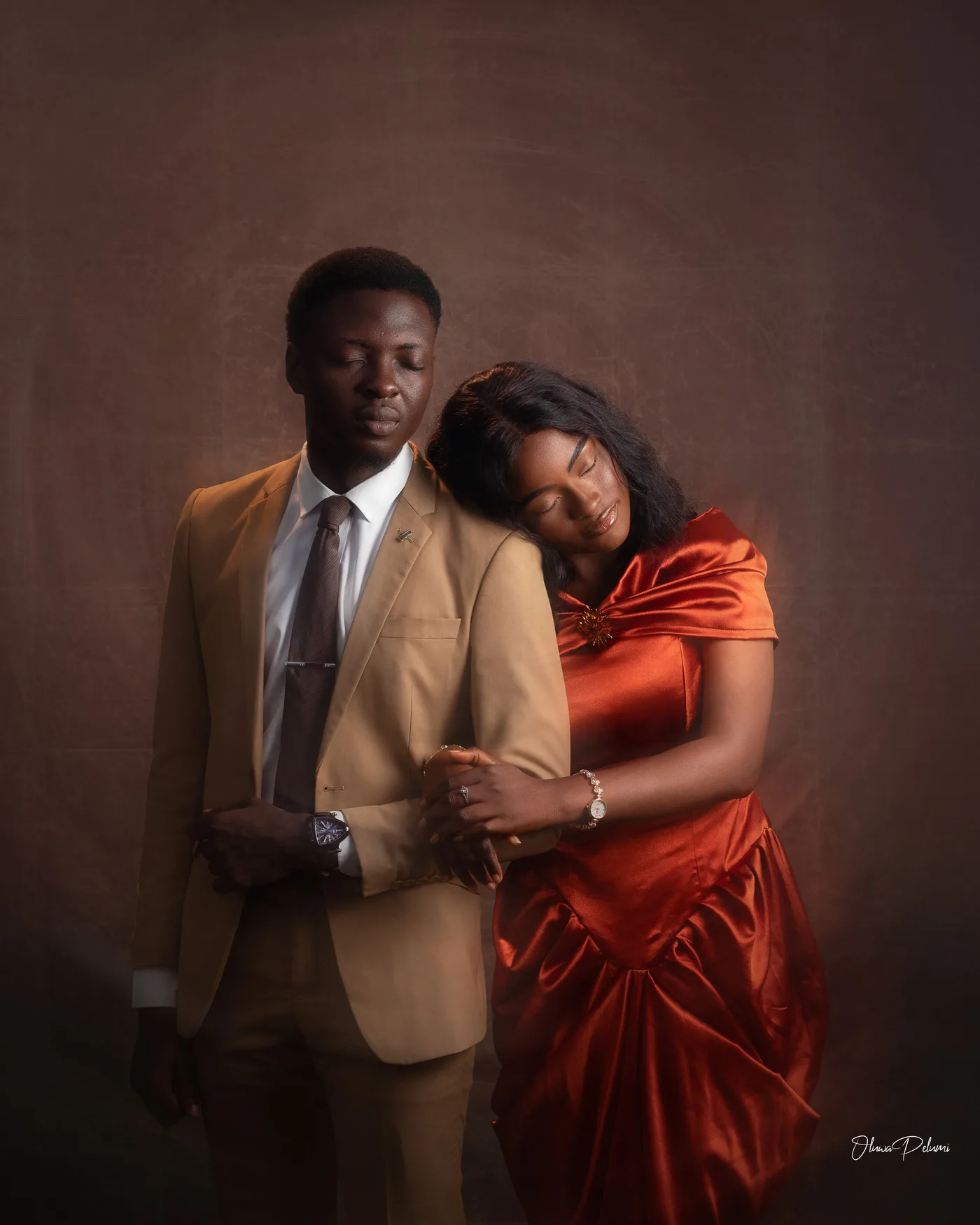 Asepe resting her head on Ajibola's shoulder, arm through his